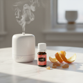 Young Living Elemi bottle on marble with citrus peel resin pieces and diffuser