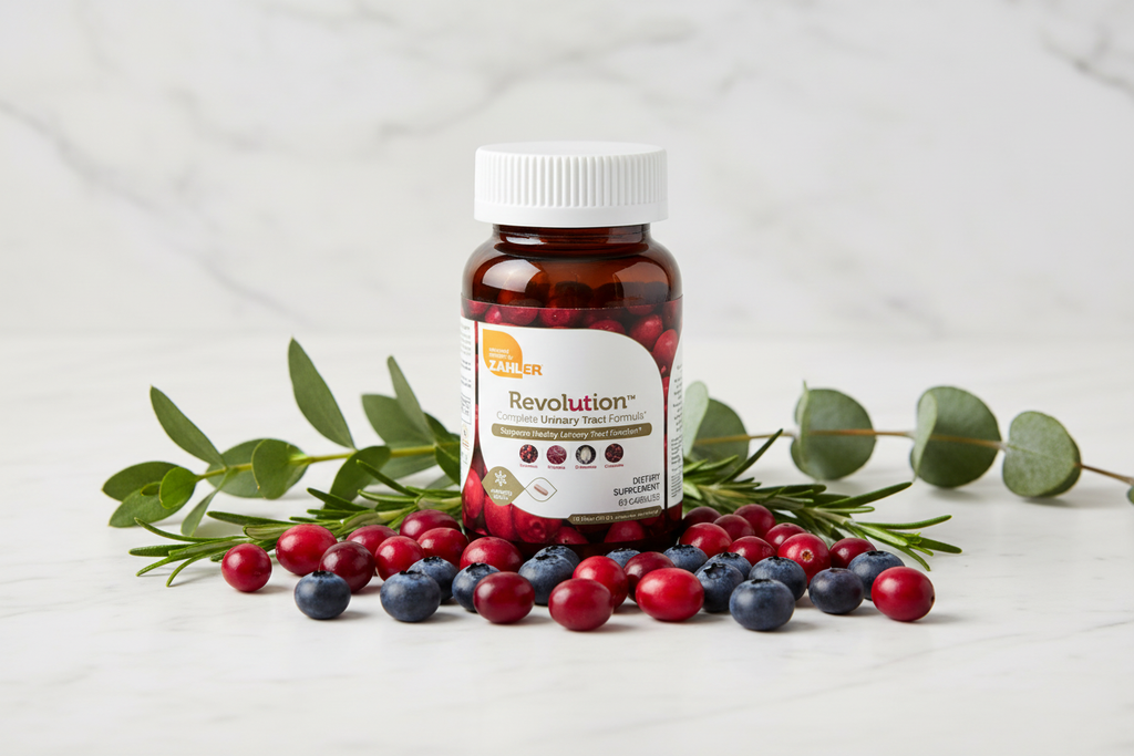 Zahler Revolution bottle on white marble with fresh cranberries and blueberries