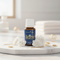 Believe essential oil on marble with white flowers