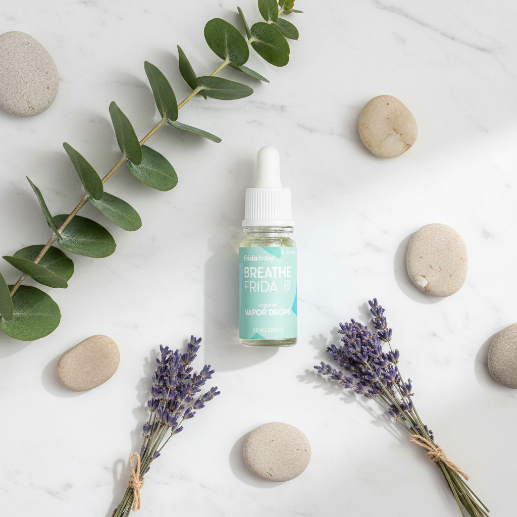 Frida Baby Vapor Drops marble flat lay with eucalyptus and lavender