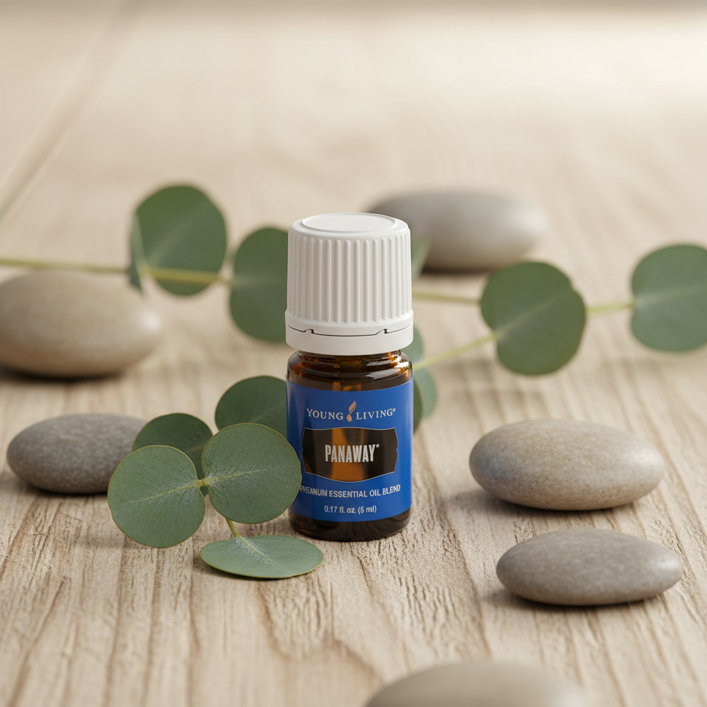 PanAway essential oil bottle on wood surface with eucalyptus and stones