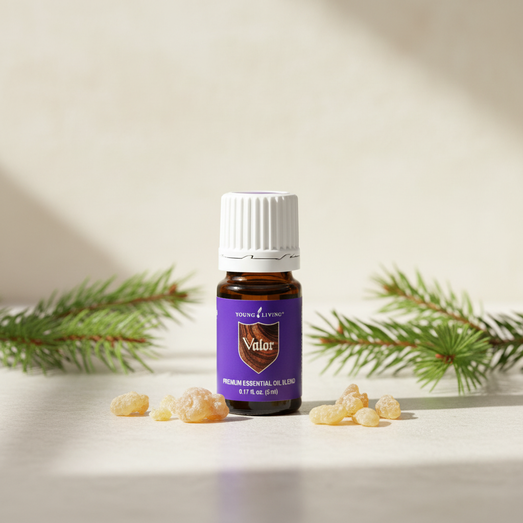 Valor essential oil bottle with frankincense resin and spruce branches on spa surface