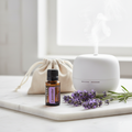 doTERRA Lavender bottle on marble with lavender sprigs and ceramic diffuser