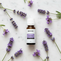 REVIVE Lavender Essential Oil marble flat lay with lavender sprigs