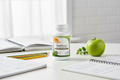 Zahler TeenFocus bottle on white desk with school notebooks pencils and green apple lifestyle photo