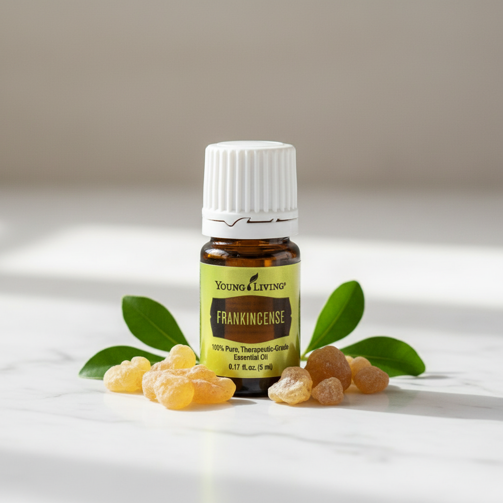 Frankincense essential oil on white marble with resin and leaves