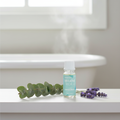 Frida Baby Vapor Drops on bathroom shelf with eucalyptus and steam