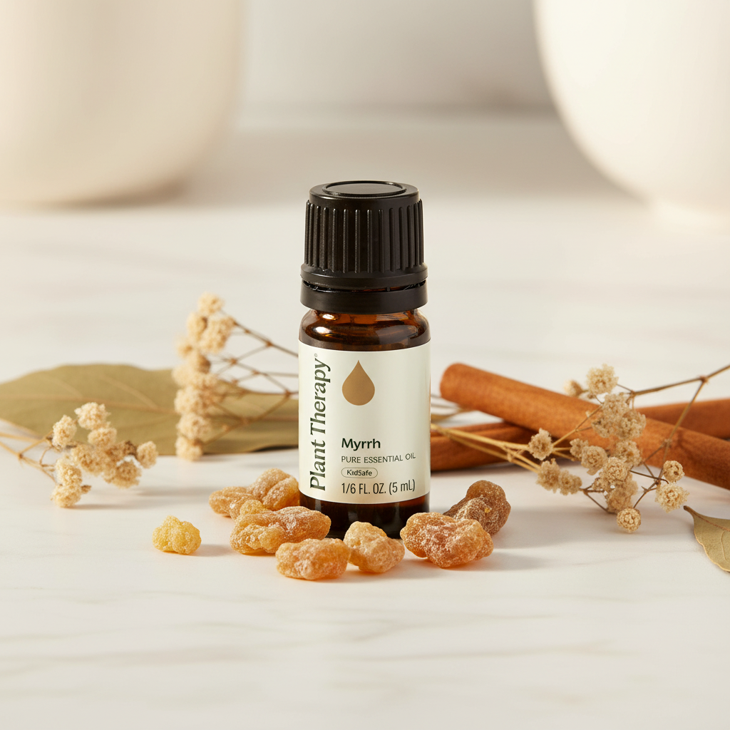 Plant Therapy Myrrh Essential Oil bottle on marble with myrrh resin pieces