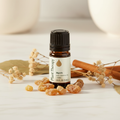 Plant Therapy Myrrh Essential Oil bottle on marble with myrrh resin pieces
