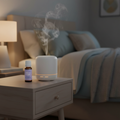 Sweet Slumber bottle next to glowing diffuser on nightstand