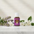 Lady Sclareol essential oil bottle with clary sage flowers and jasmine on spa surface