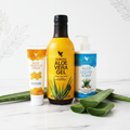 Forever Living Aloe Bundle on white marble with botanicals