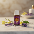 Release essential oil on marble with lavender and ylang ylang flowers